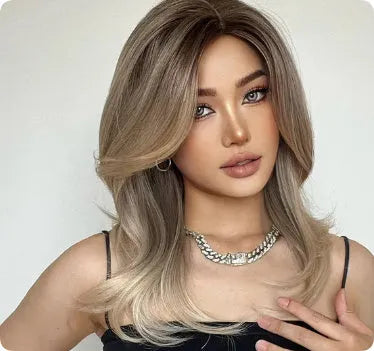 Mid-length curly full-head synthetic wig with long bangs in a platinum gradient colour.
