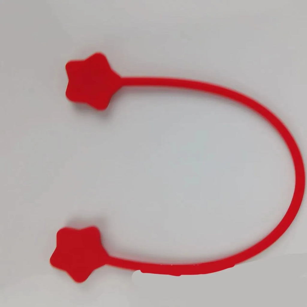Purple silicone star-shaped magnet winder for clipping onto and organising headphone or phone charging cables.