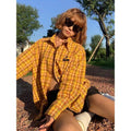 Dopamine yellow plaid shirt on a hanger, showing loose cardigan-style fit.