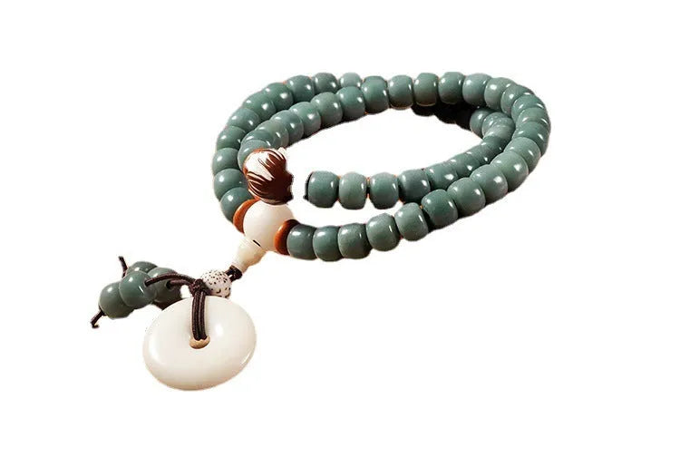 Unisex natural Bodhi seed bracelet with white jade beads and green sandalwood on a white background.