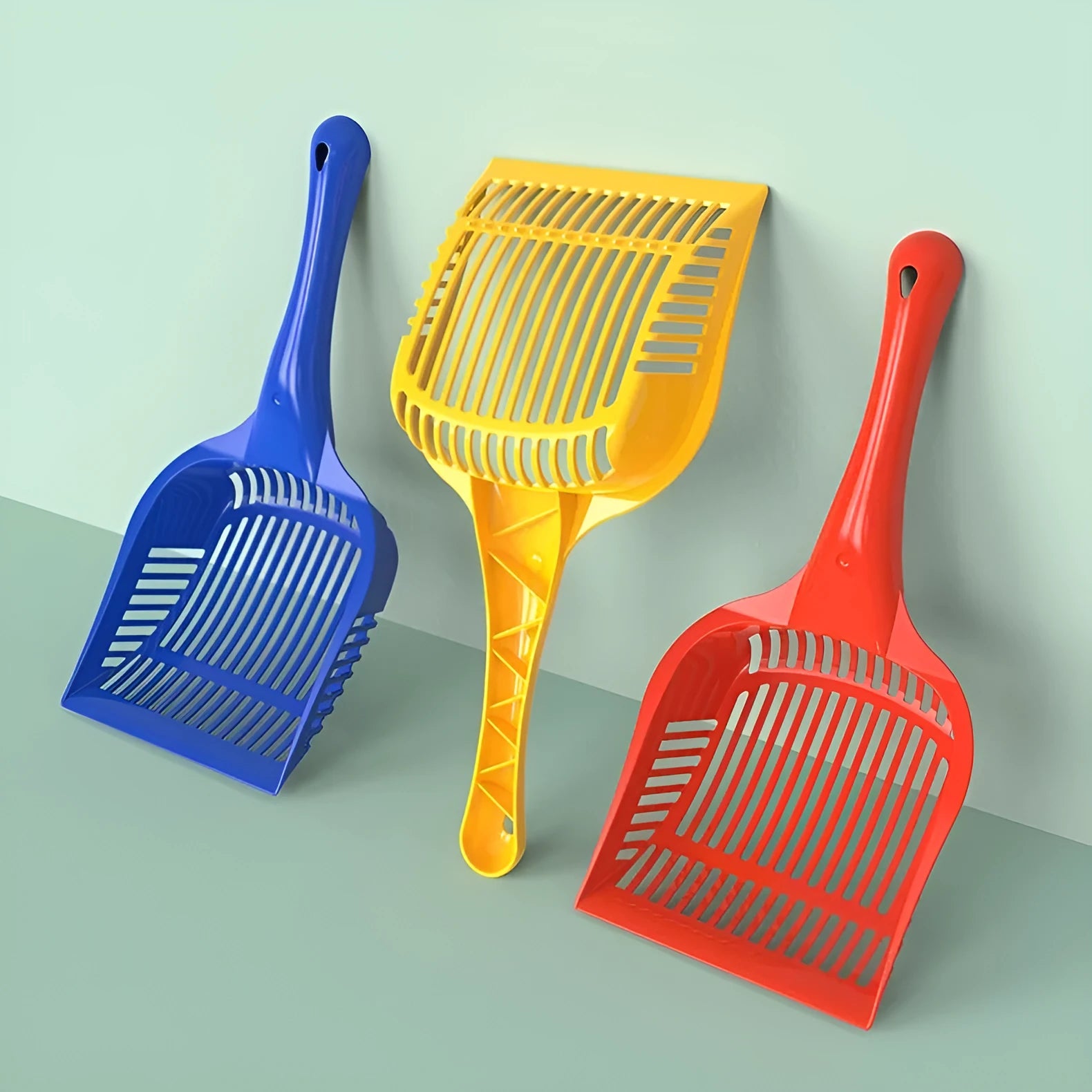 Plastic cat litter scoop with ergonomic handle in red, yellow, or blue colour options