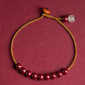 Hand-woven raw ore cinnabar bracelet with Hetian jade accents in a geometric design.