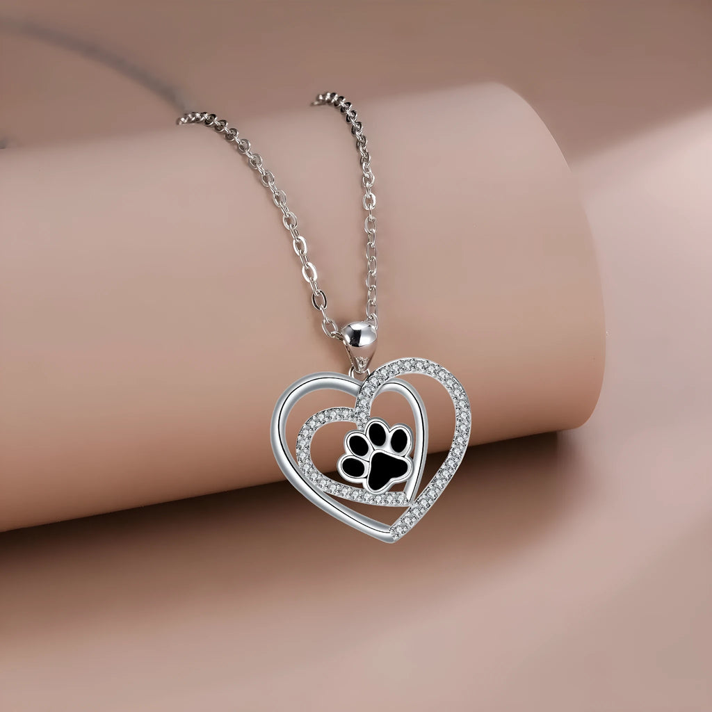 Women's dog paw print pendant necklace with electroplated copper finish on a cross chain.