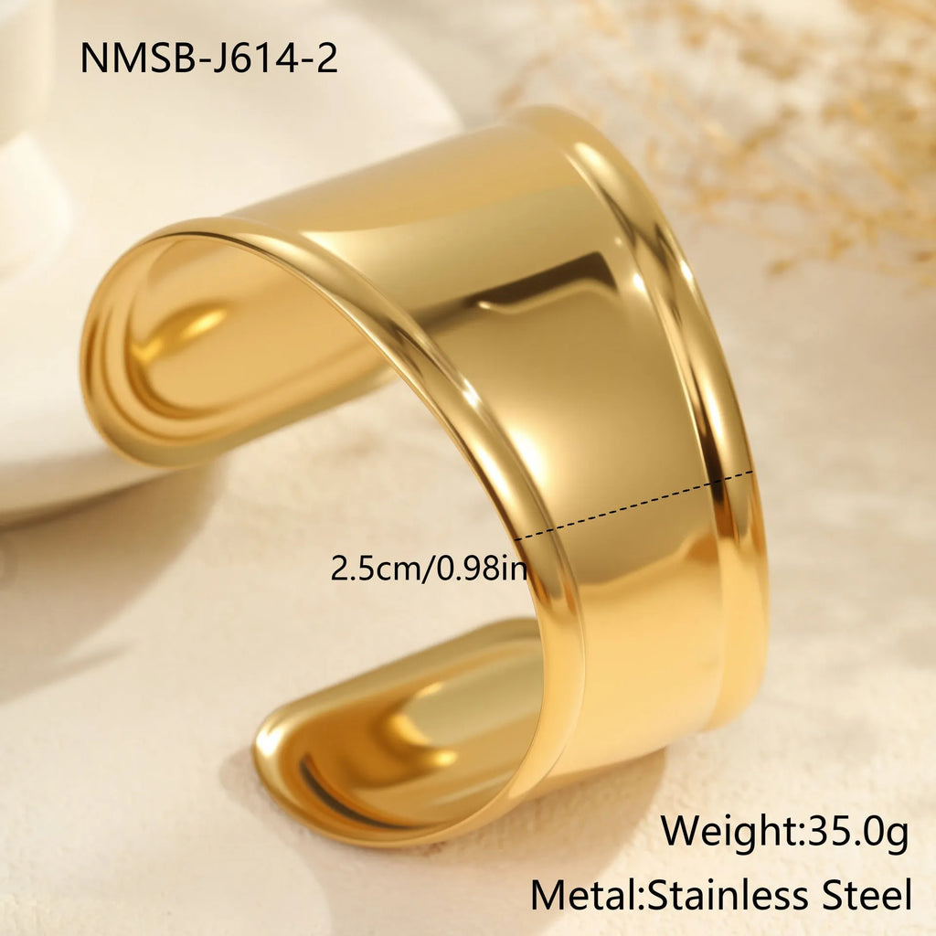 Gold plated stainless steel wide bracelet for women with geometric wave design and niche opening clasp