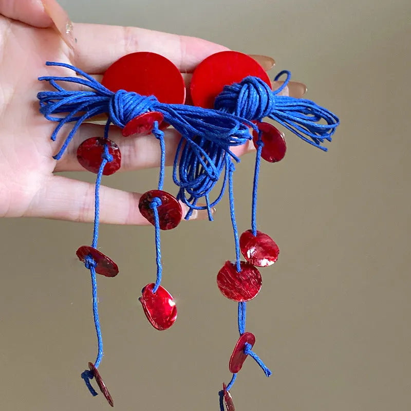 Women's geometric earrings with blue resin flower design on cloth material