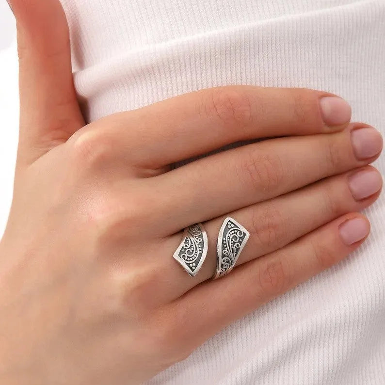 Silver-colour adjustable opening women's ring with retro minimalist design on white background
