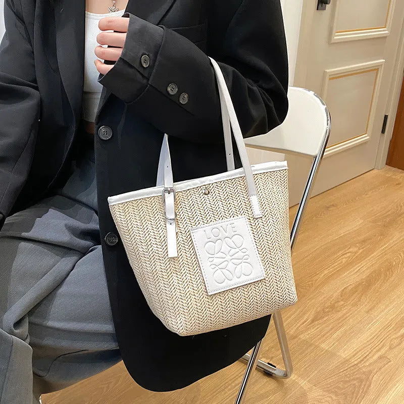 Straw woven women's shoulder bag in black showing European retro style with three-dimensional pocket