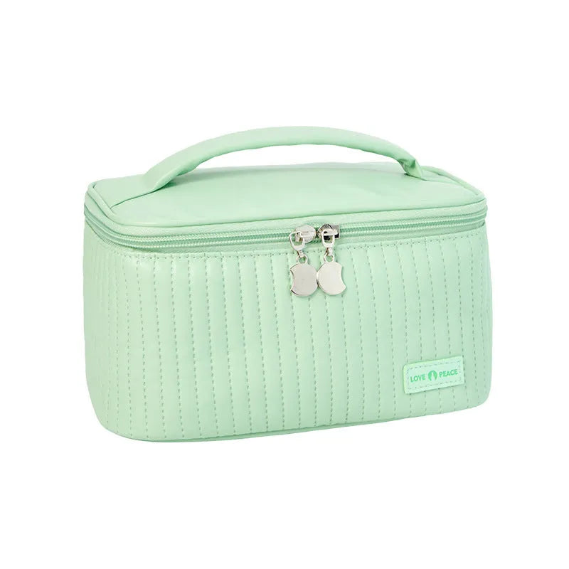 Open-top cake-shaped makeup bag in PU leather, shown in a solid colour from the pink, coffee, beige, blue, green, purple range.