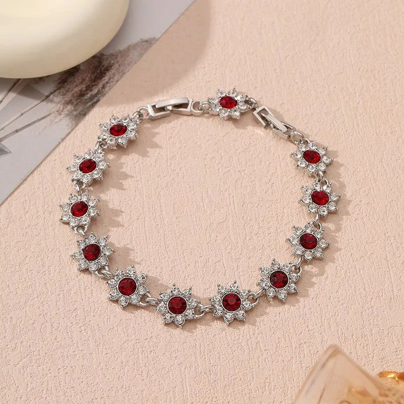 Gold and silver electroplated flower bracelet with coloured gemstone accents on zinc alloy