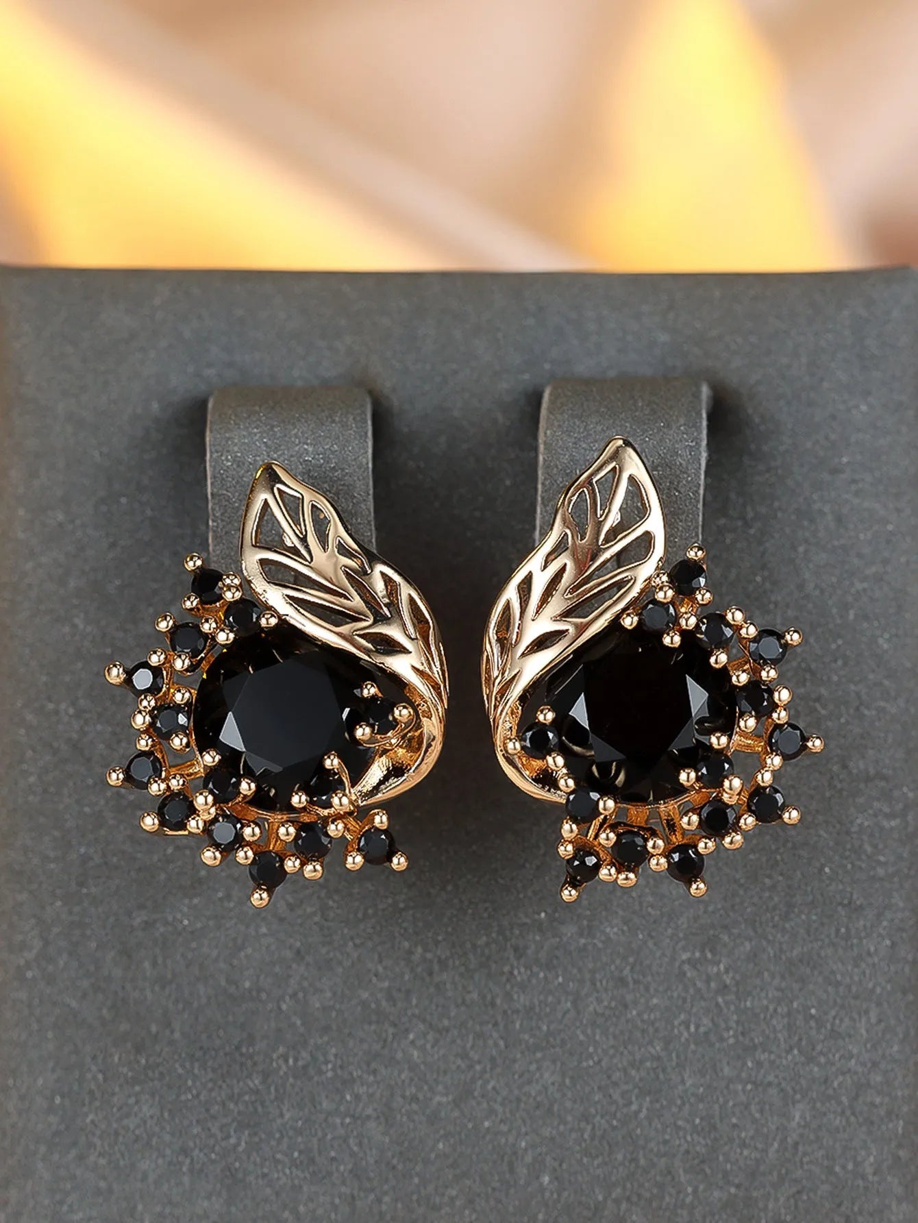 Round floral earrings with feather detailing and coloured zircon stones in champagne gold finish