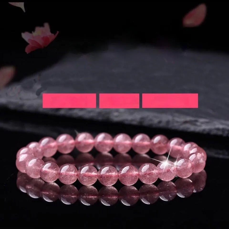 Women's strawberry quartz crystal bracelet showing polished beads in 6mm, 8mm, and 10mm size options