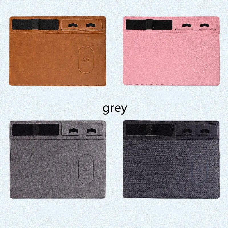Pink wireless charging mouse pad with integrated phone holder on a desk, showing 320 x 260 mm size.