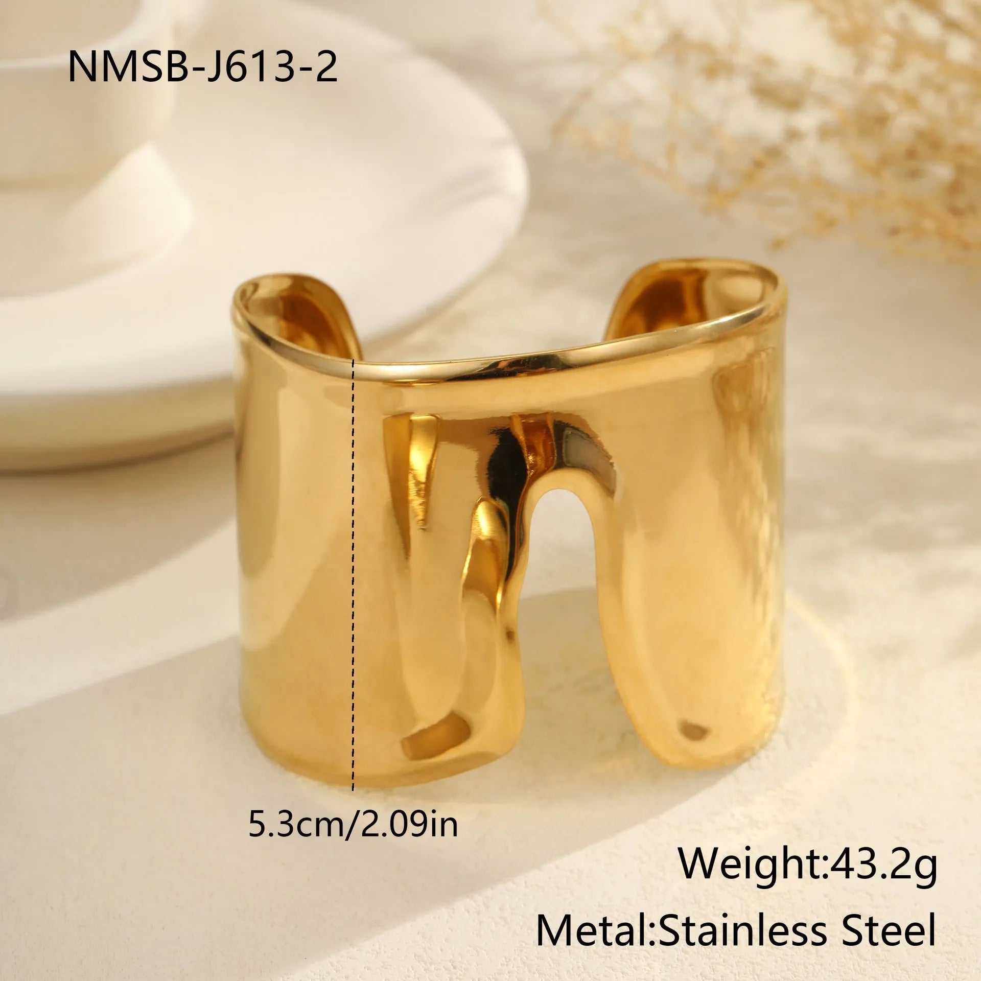Gold plated stainless steel wide bracelet for women with geometric wave design and niche opening clasp