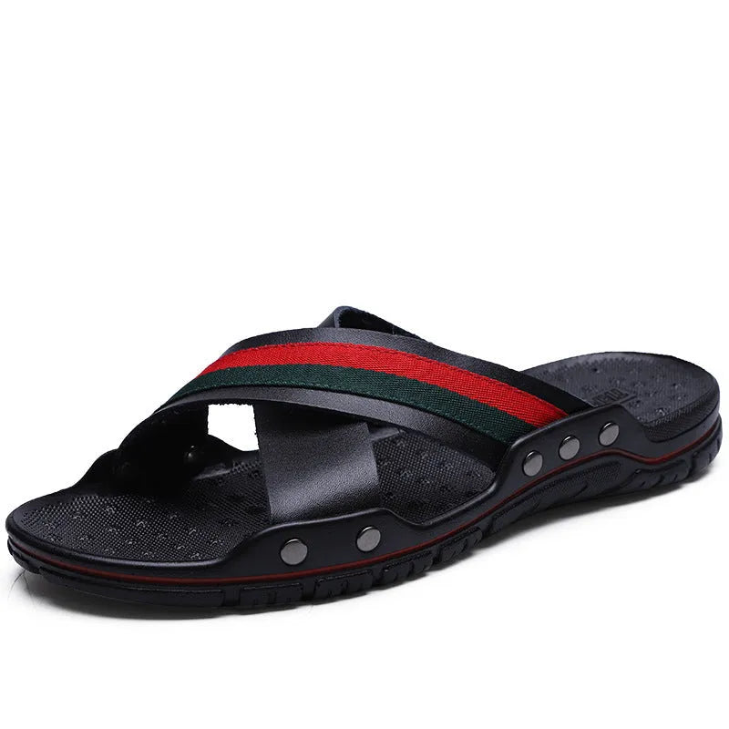 Men's white cowhide leather flip flops on a sandy beach background.