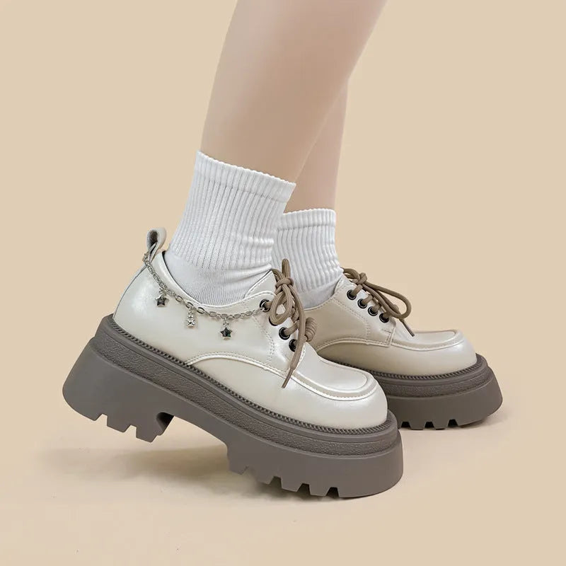 White platform Mary Jane shoes with chunky heel and round toe, front lace-up design