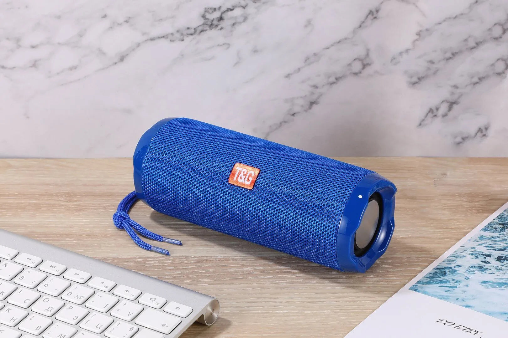 Fabric-covered portable Bluetooth speaker in multiple colours showing card holder slot.