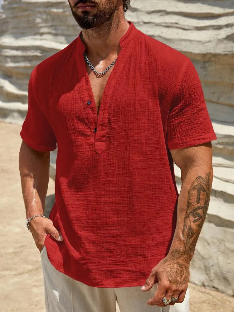 Men's solid colour short-sleeve shirt with a stand collar on a hanger.