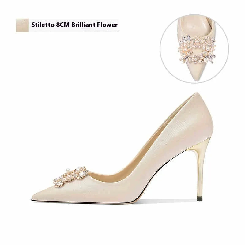 Rhinestone decorated pointed-toe bridal high heels on a white background.