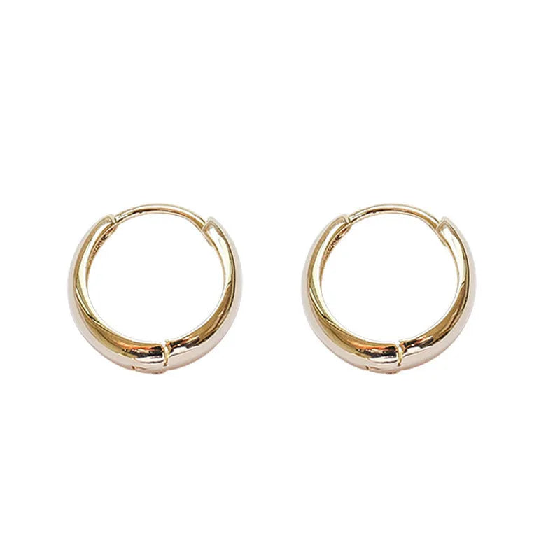 Women's minimalist copper water drop earrings in gold or silver, shown in large, medium, and small sizes.