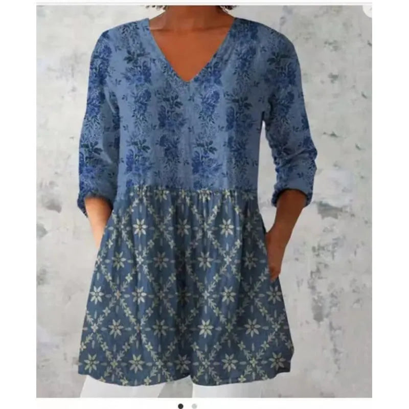Women's printed loose wave dress with wide waist and three-quarter sleeves in a floral pattern.