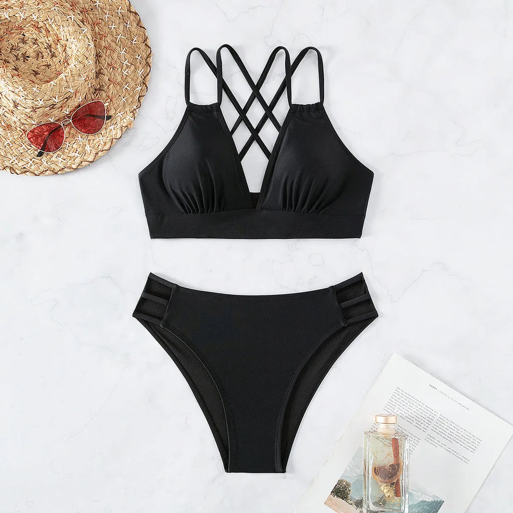 Women's black halter neck bikini swimsuit with V-neck top and split shorts on mannequin