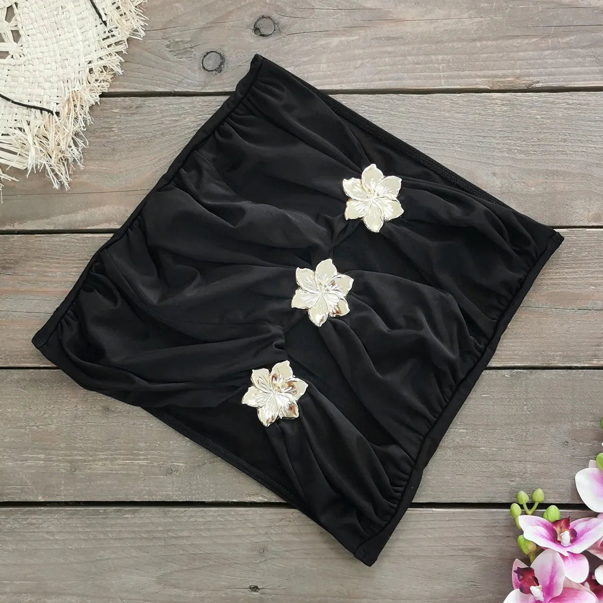 Women's solid colour one-piece swimsuit with a short skirt and hollow-out tube top design.