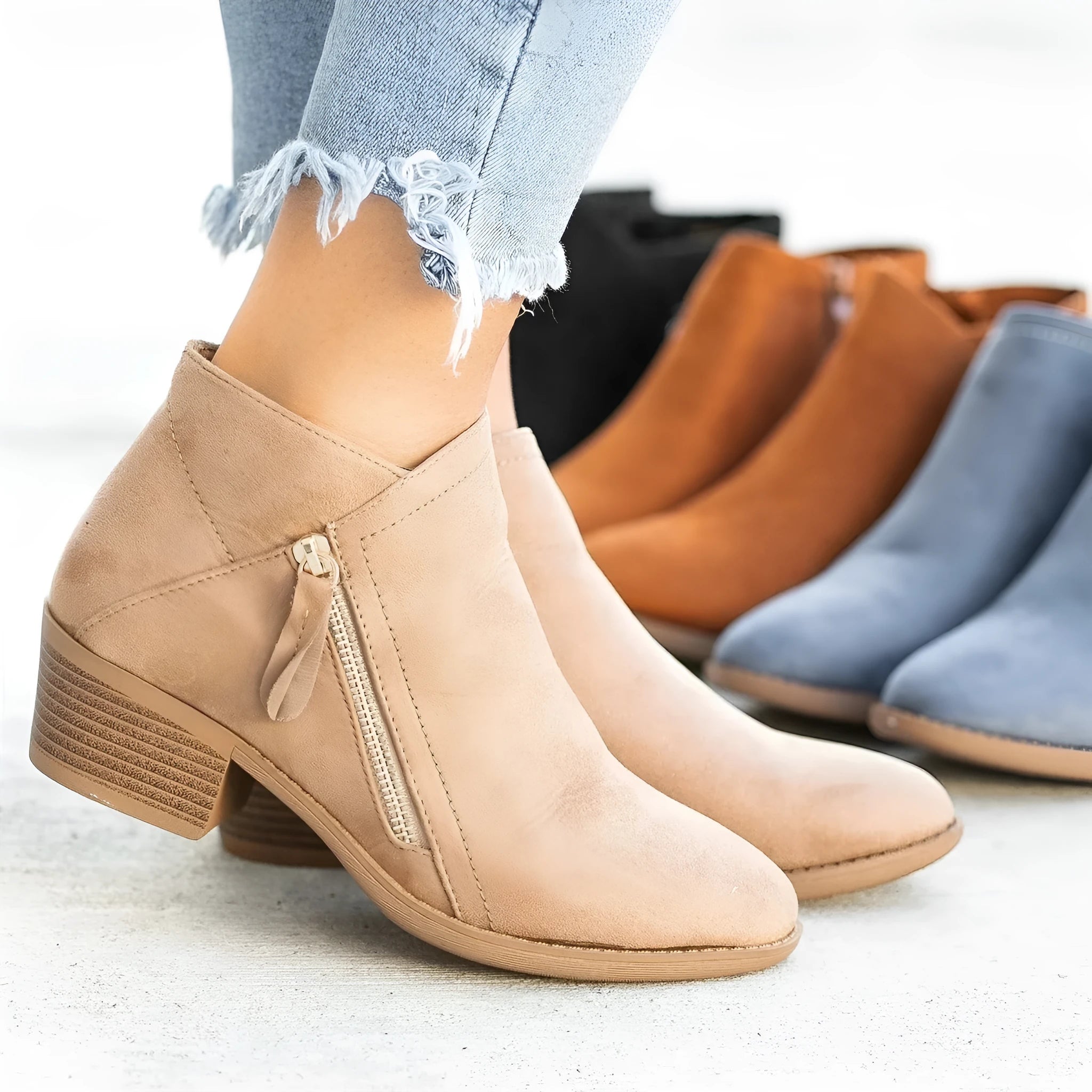 Women's suede ankle boot with side zip, chunky heel, in beige, black, blue, or orange.