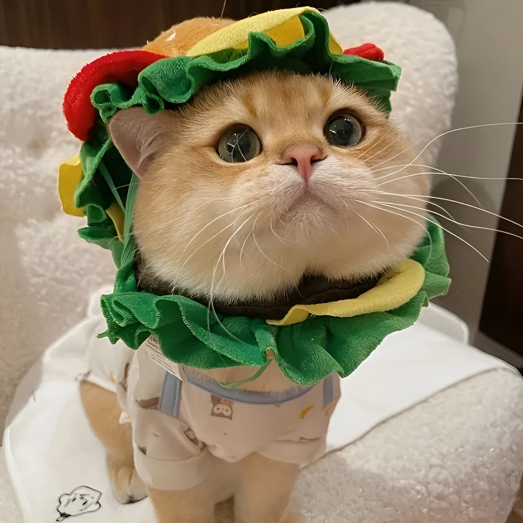 Cartoon-style burger headdress hat for cats, shown in soft fabric with adjustable strap.