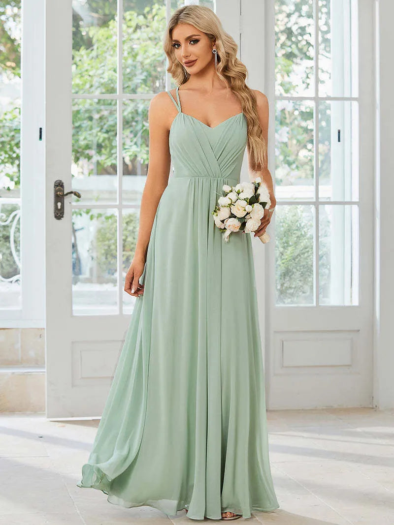 Women's long sleeveless A-line pleated dress in light green for banquet or casual wear.