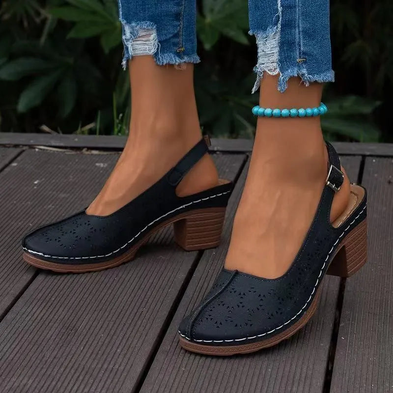 Women's closed toe wedge sandal in PU leather with a round toe and rubber wedge sole.