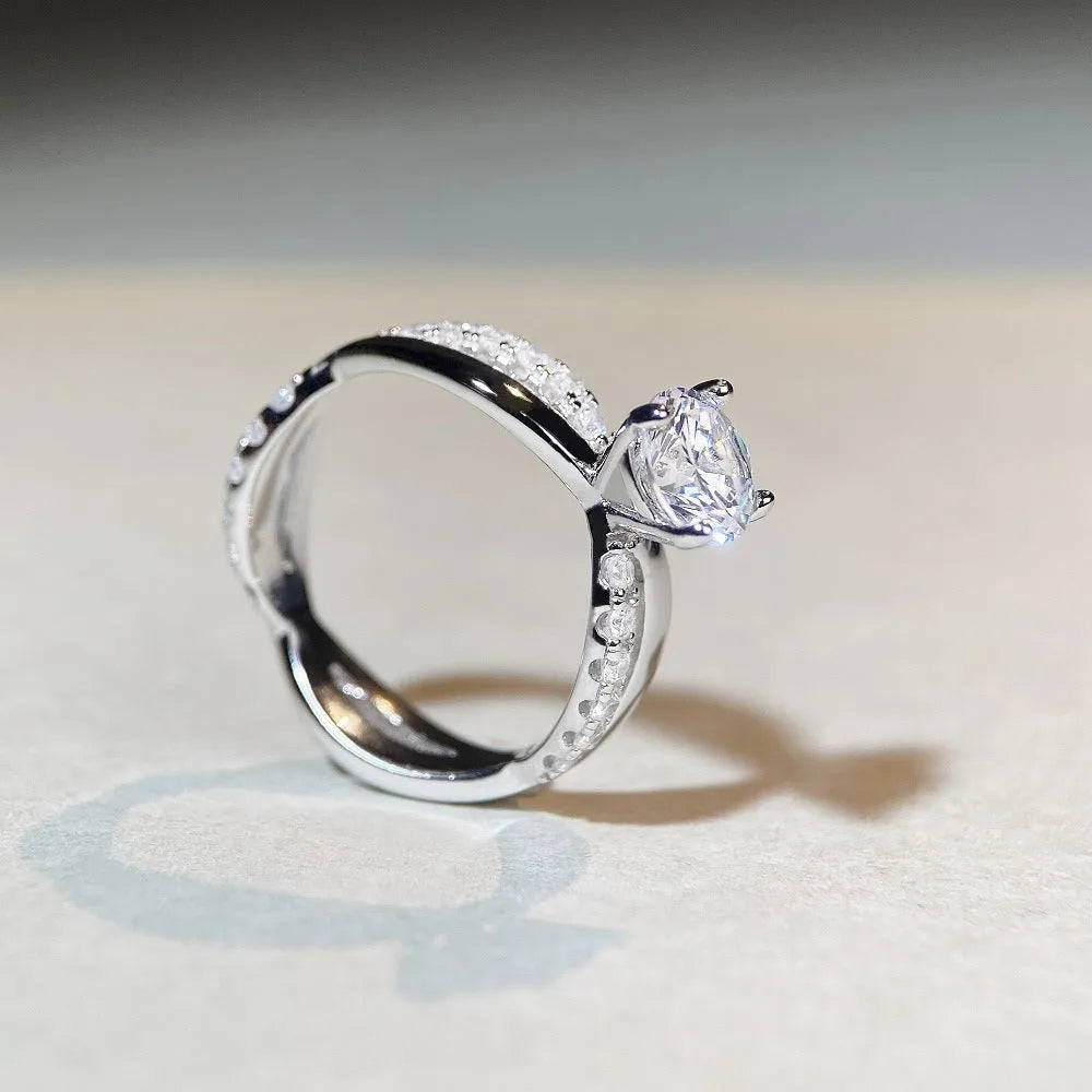 Geometric silver ring with 1 karat moissanite stone in four-claw setting and twisted arm winding band