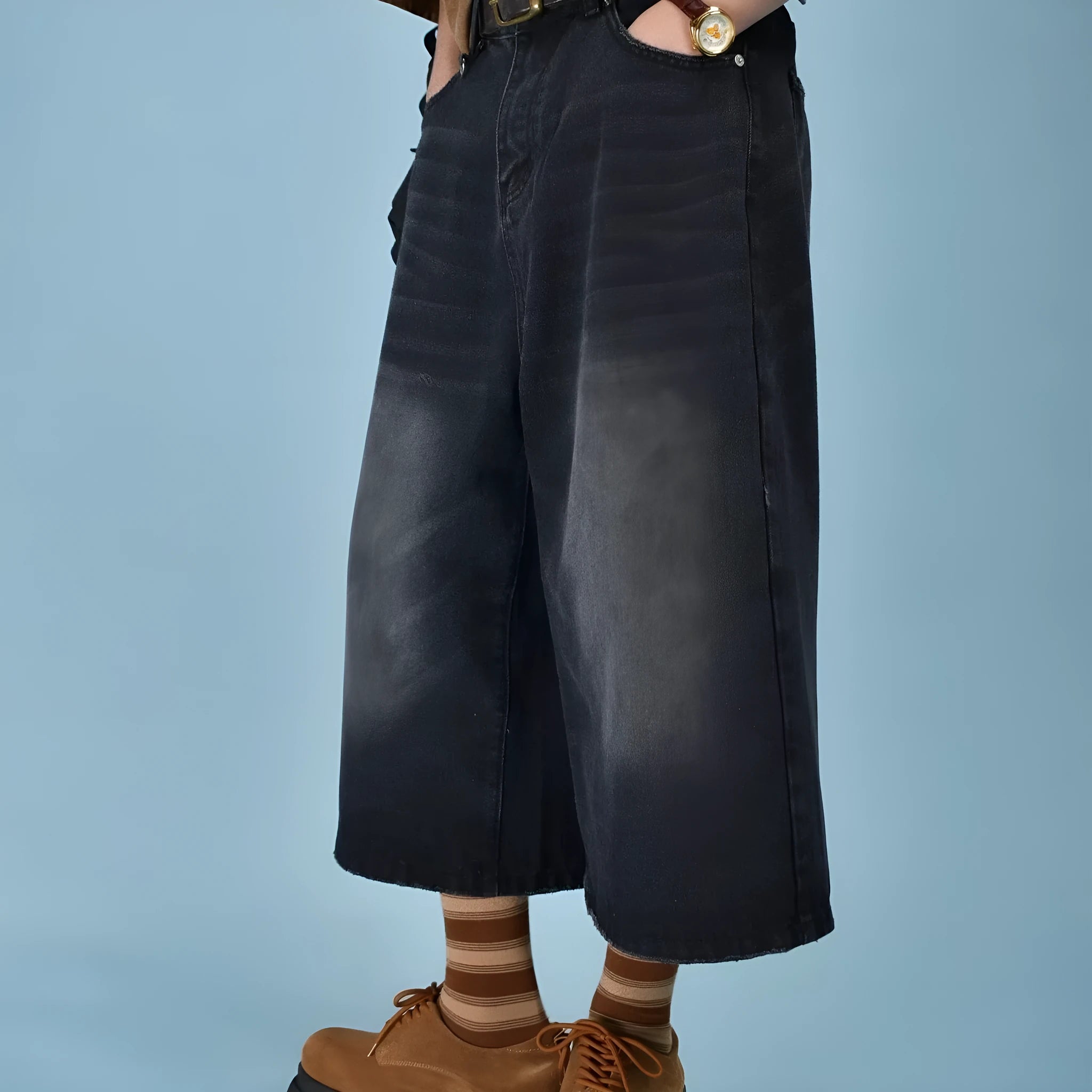 Man wearing blue loose straight-leg denim shorts with a simple summer style.