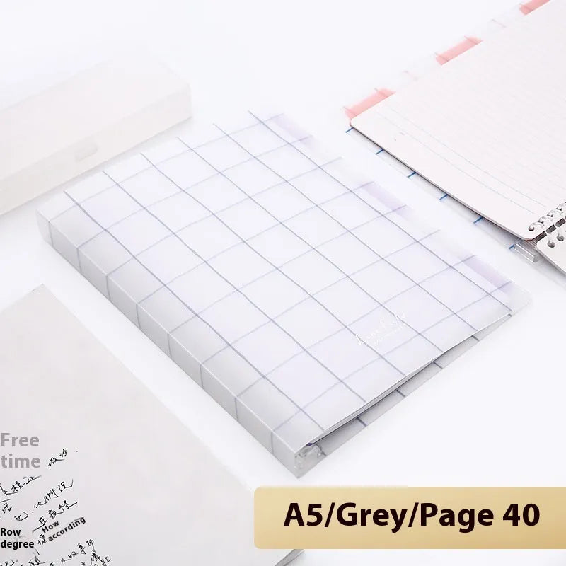 Refillable loose-leaf spiral notebook with PP cover open, showing raw wood pulp paper in grid ruling.