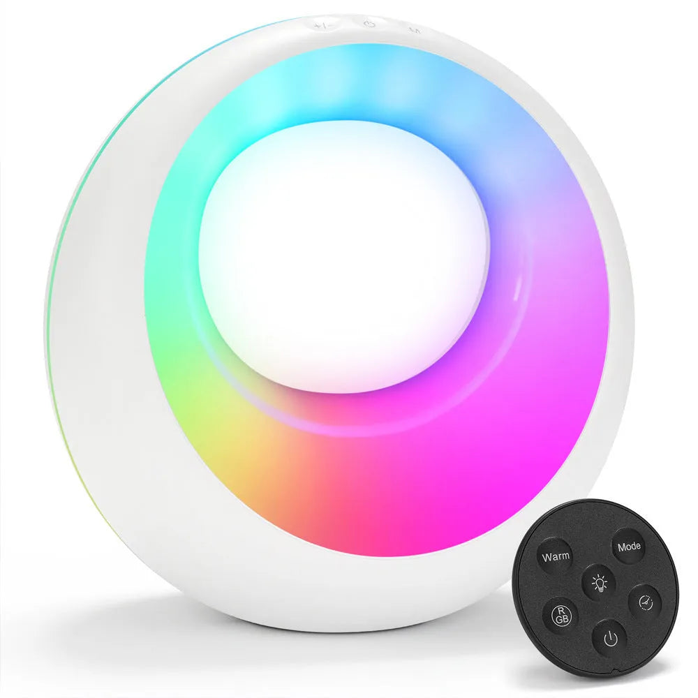 Small RGB colour changing night lamp with remote control on bedside table