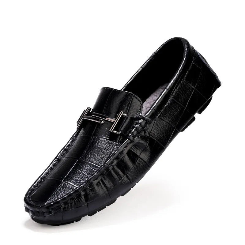 Men's black leather casual shoes with a silver belt buckle and flat rubber sole.