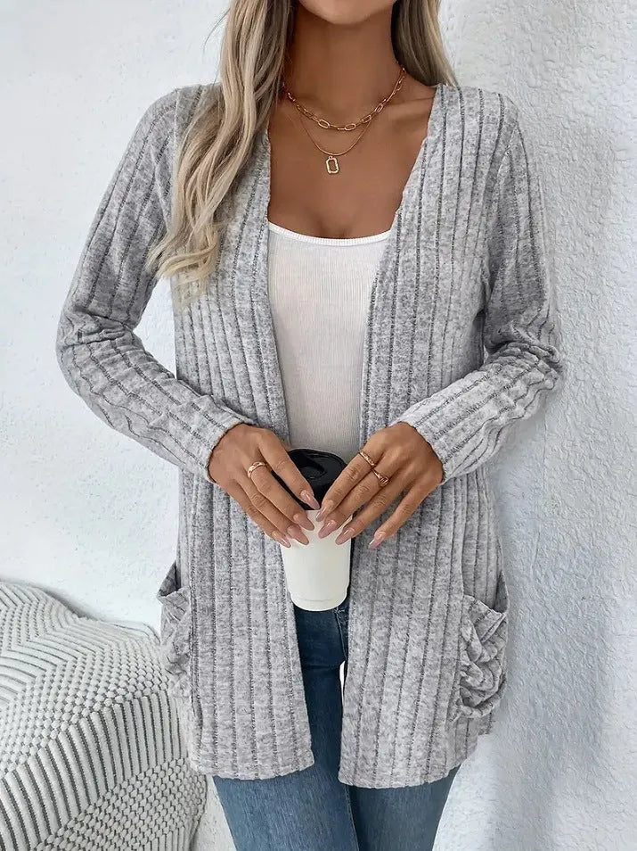 Solid colour long sleeve cardigan with front pockets in a loose fit, shown in grey.