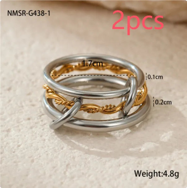Stacked gold plated stainless steel ring set with exaggerated design on hand