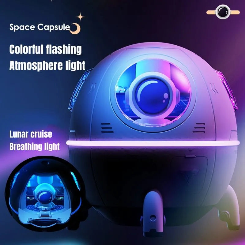 Purple astronaut-shaped USB desktop humidifier with LED light on a desk next to a laptop.
