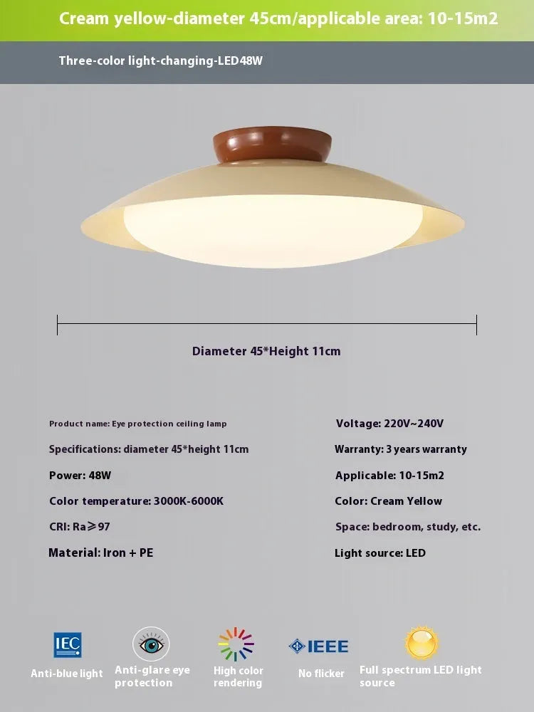 Modern cream-style flying saucer shaped ceiling lamp in a bedroom setting.