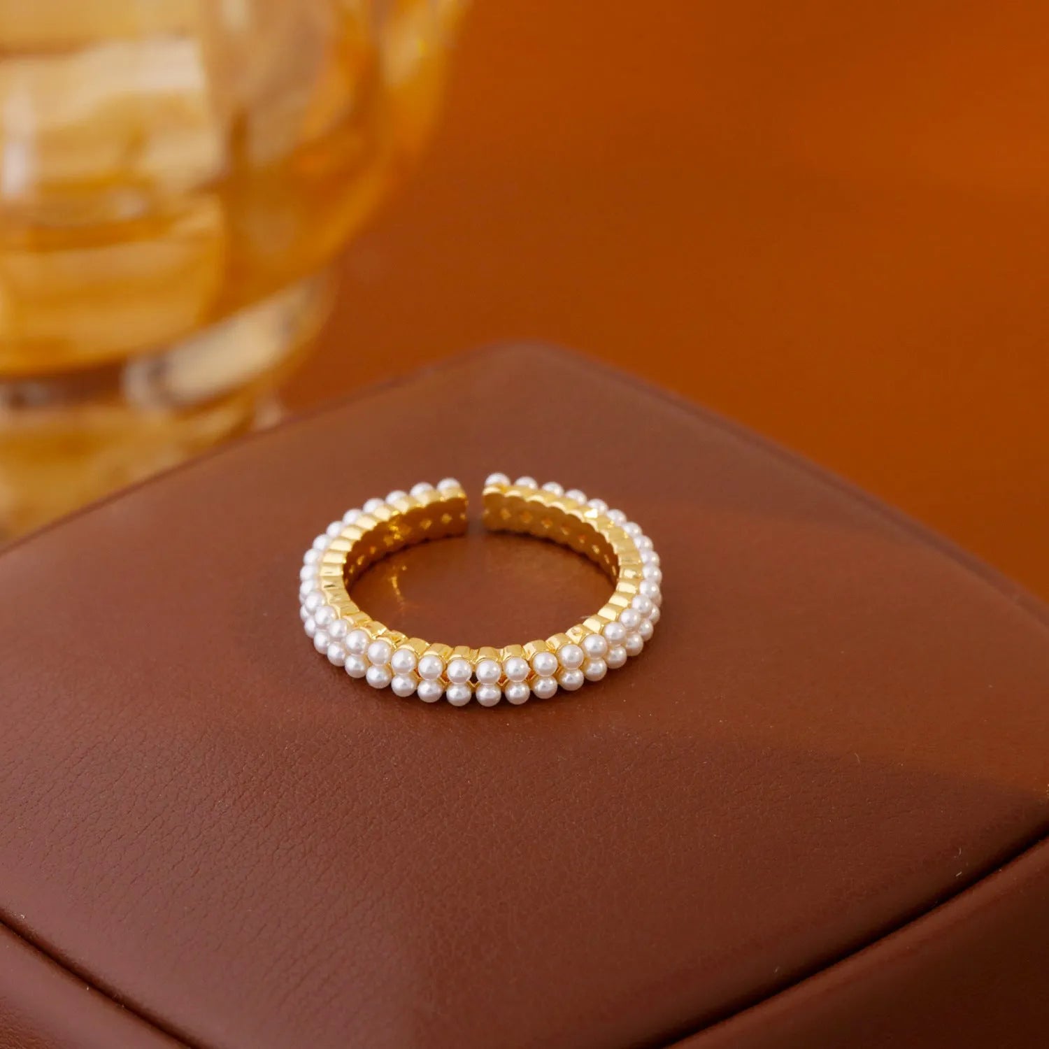 Geometric open mouth ring with electroplated gold finish and round pearl elements