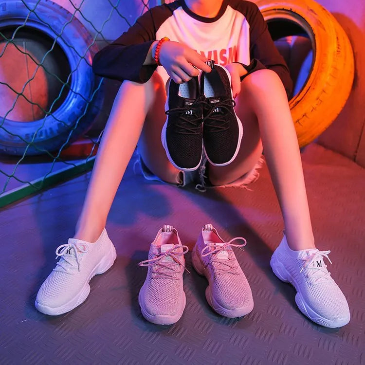 White women's thick-soled flying woven sports shoes with a front strap and rubber sole.