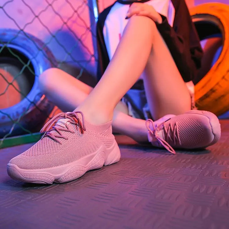 White women's thick-soled flying woven sports shoes with a front strap and rubber sole.