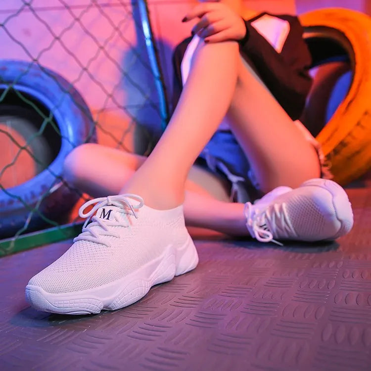 White women's thick-soled flying woven sports shoes with a front strap and rubber sole.