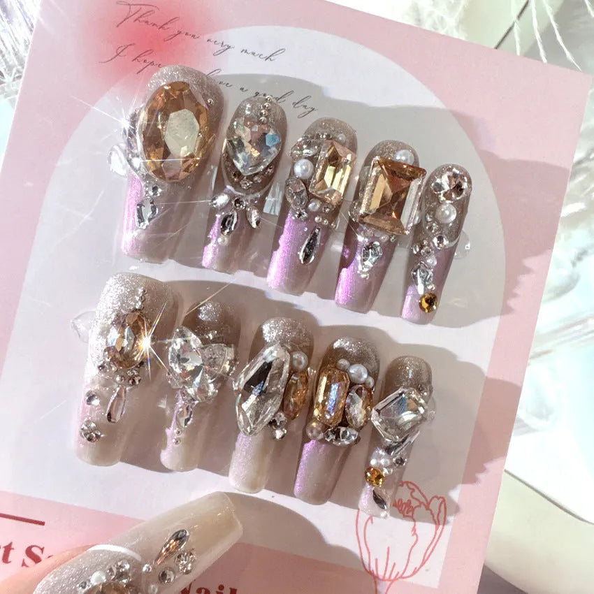 False nail patches with rhinestone decoration on card paper packaging with application tools