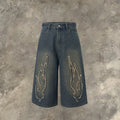 Men's black denim shorts with flame embroidery patch detail, cropped length and straight leg street style