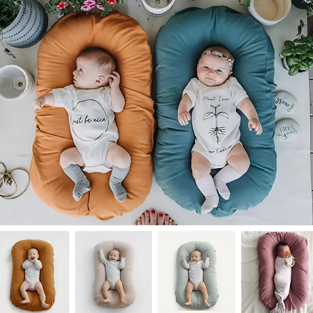 Beige portable cotton baby nest crib for newborns measuring 75cm by 45cm on a neutral background