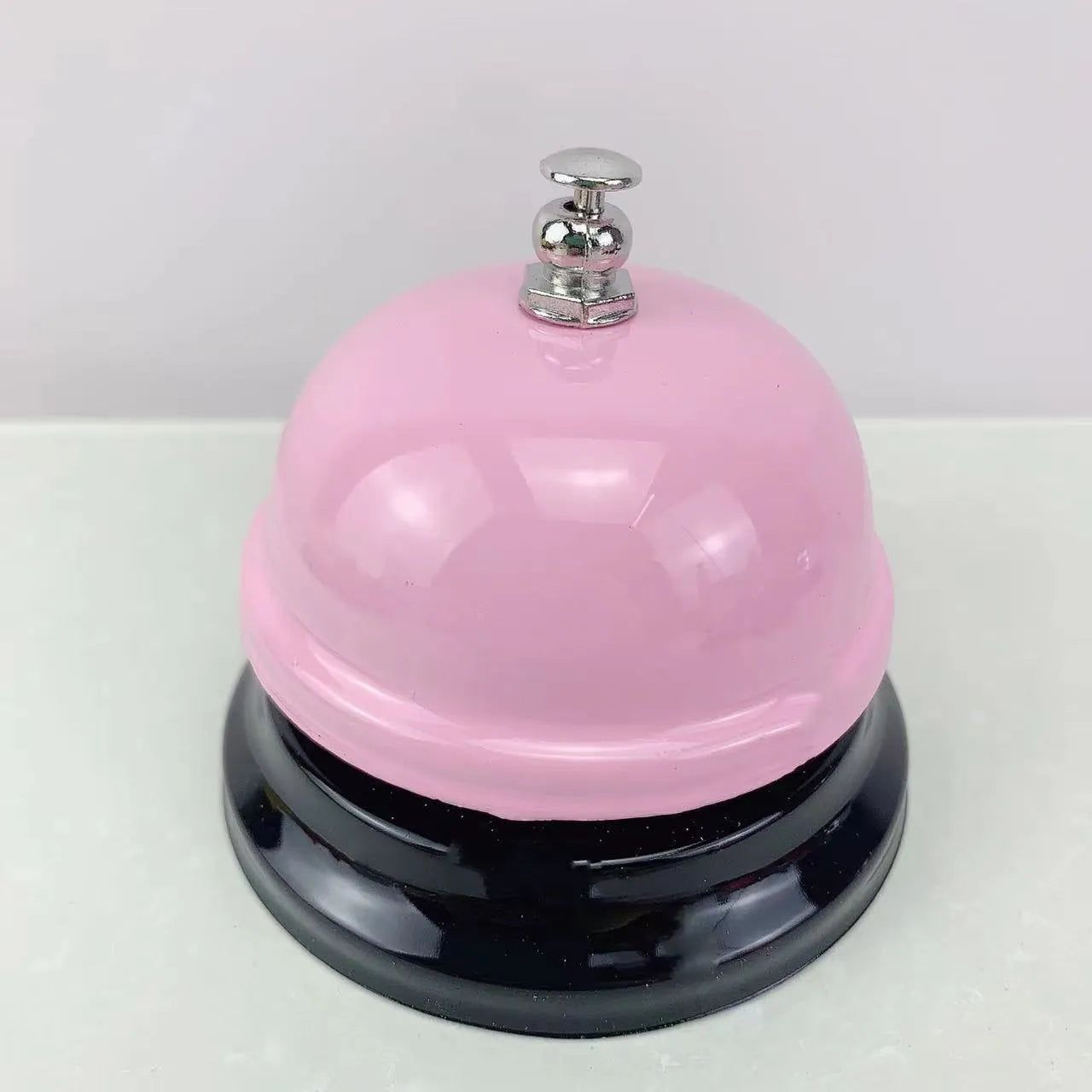 Handheld iron game bell in one of ten colours like red, blue, or green tea, for classroom or restaurant use.