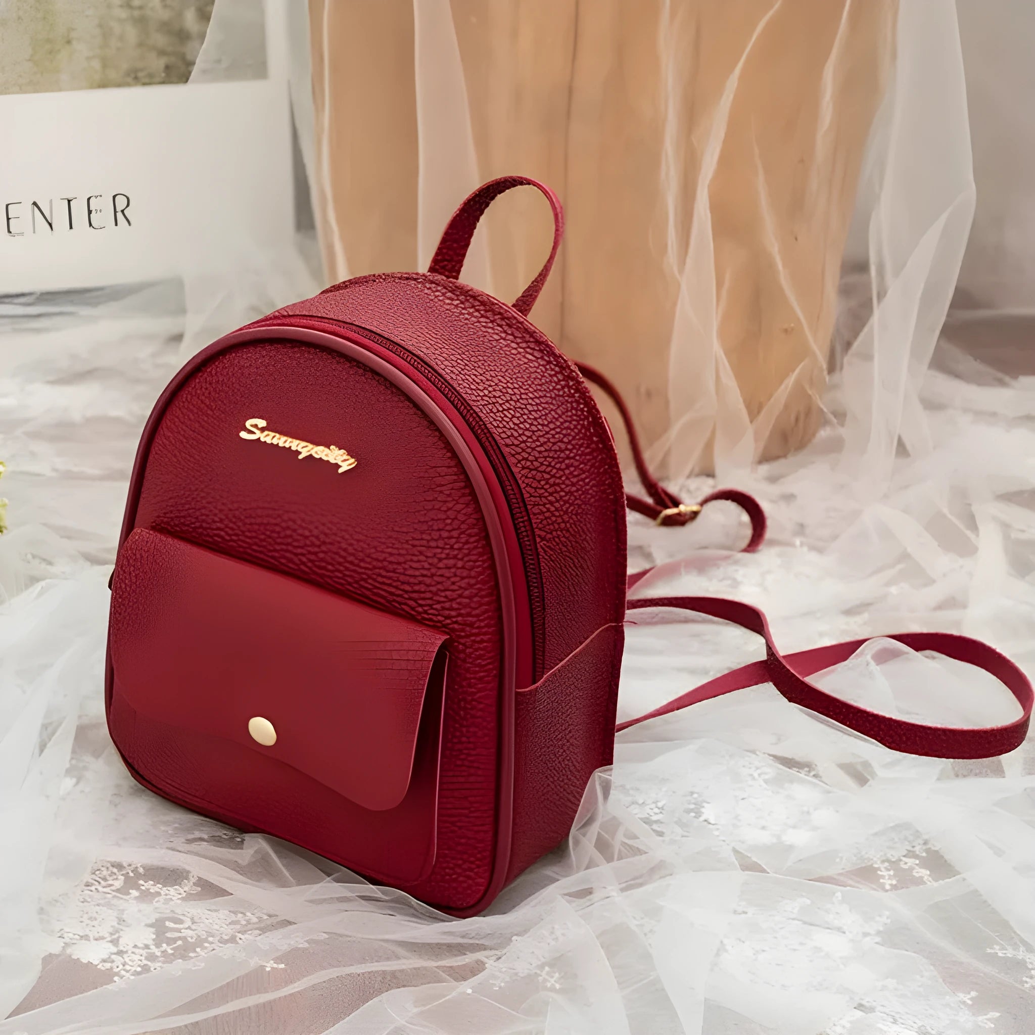 Women's black PU backpack purse with letter design and shoulder strap showing compact 18.5cm length
