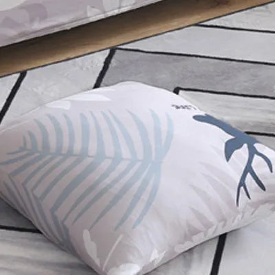 Geometric abstract printed stretch sofa slipcover covering a three-seater sofa with matching cushion covers.