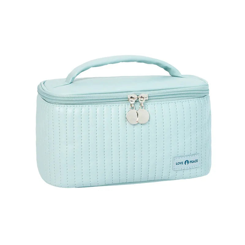 Open-top cake-shaped makeup bag in PU leather, shown in a solid colour from the pink, coffee, beige, blue, green, purple range.